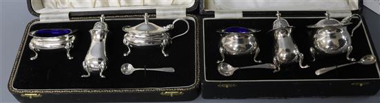Two cased silver three piece condiment sets (varying dates).